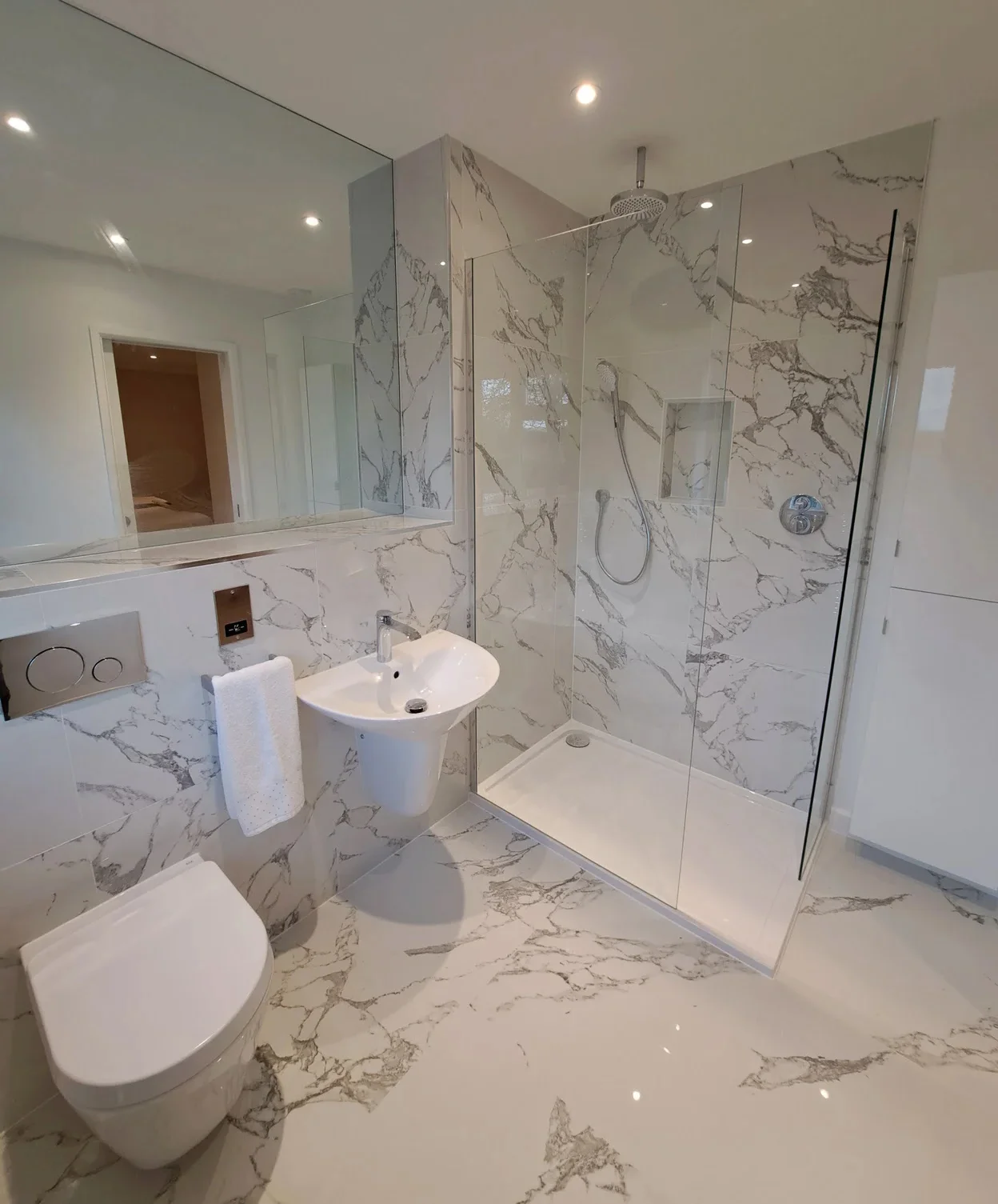 Kitchen fitters, Marlborough. An airy, light modern bathroom with marble affect walls and floors. For page: Testimonials, Bathroom & Kitchen Fitters Devizes and Marlborough